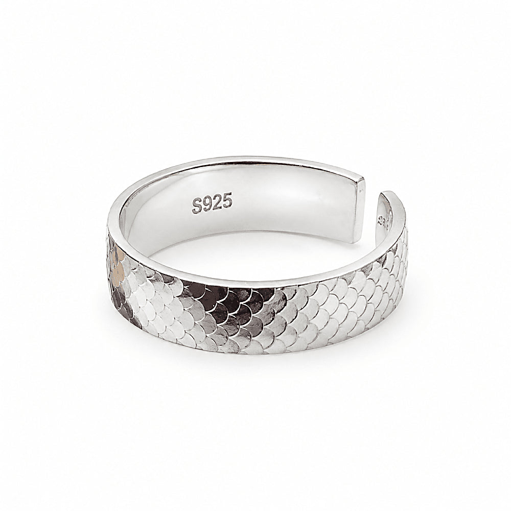 Discover the Mermaid Band Sterling Silver Ring at The Luxe Maison, featuring a wide S925 sterling silver band with intricate fish scale-inspired detailing and a polished finish. With its adjustable open-back design and ocean-inspired elegance, this bold statement ring adds a touch of coastal charm to everyday looks and layered silver jewelry.