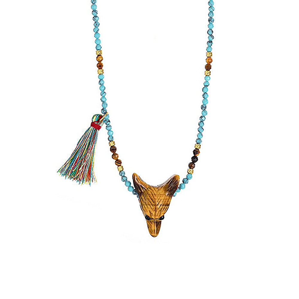 Discover the Wild Spirit Wolf Multi-Stone Necklace at The Luxe Maison, featuring a hand-carved tiger's eye or rose quartz wolf pendant, natural gemstone beads, golden accents, and a colorful tassel for a bold, bohemian look.