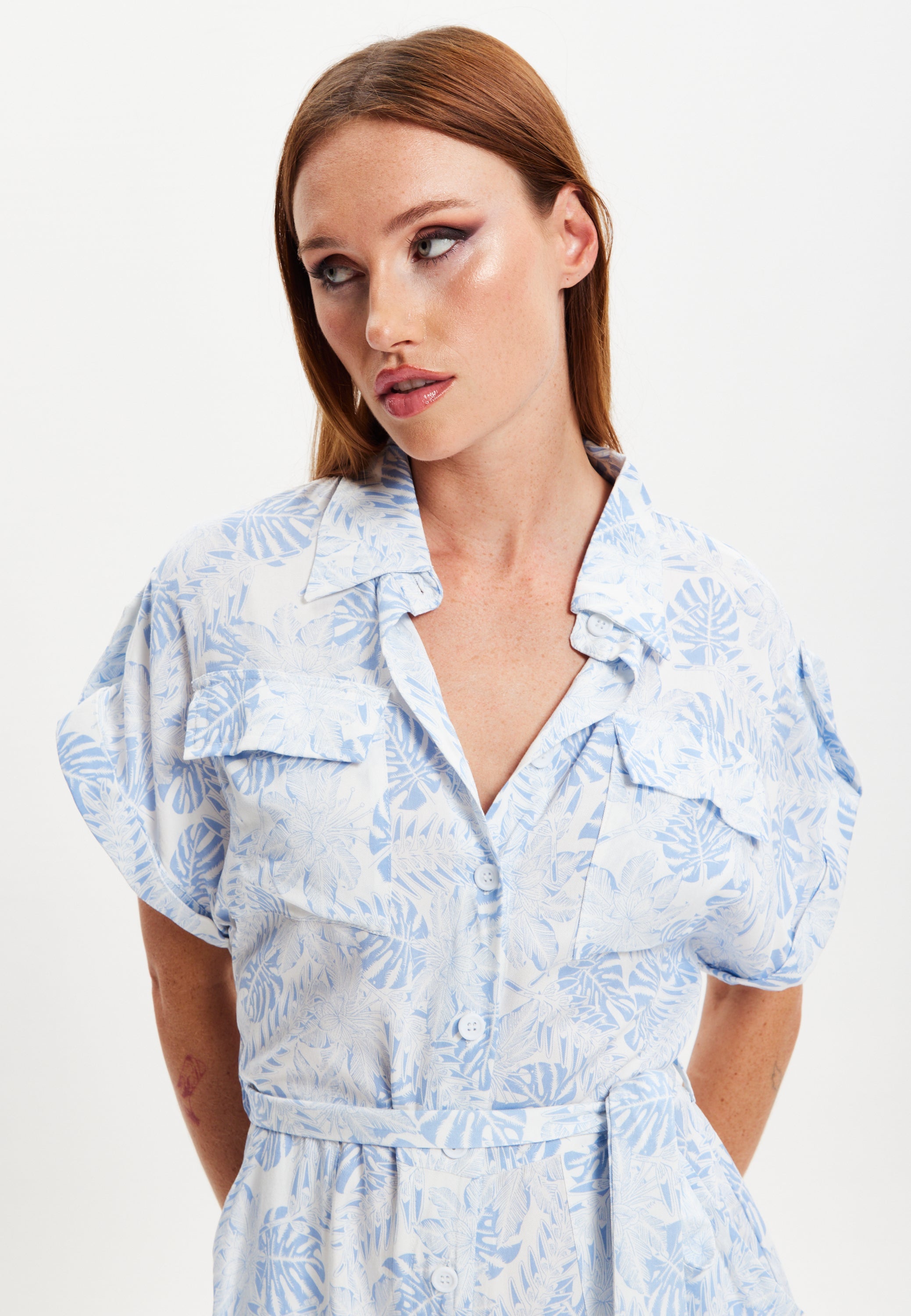 Women's Blue Leaf Printed Playsuit with Button Down, Short Sleeve, Front & Side Pockets, Loose Fit, Casual Style.