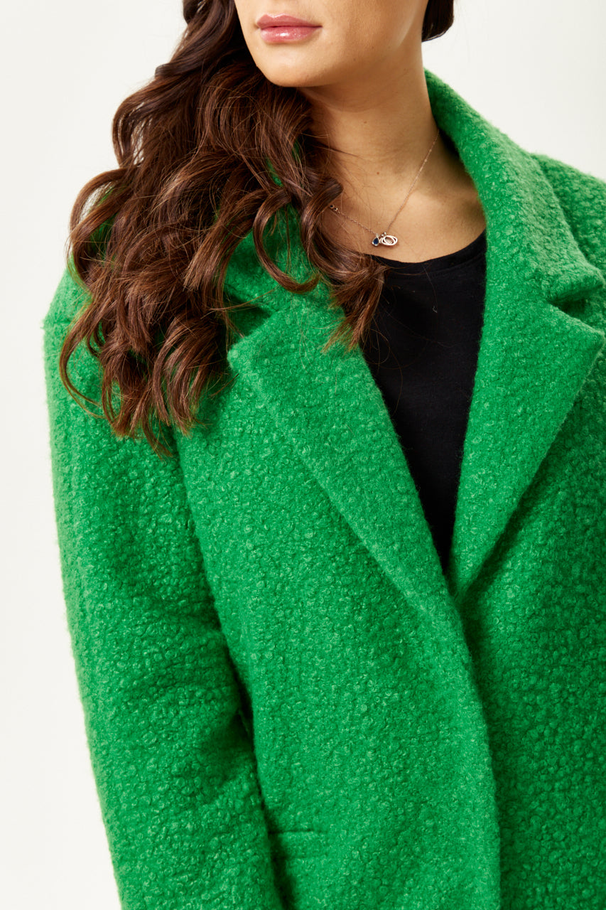 Discover online dress stores featuring a women’s fluffy green bouclé coat for standout winter style. Shop Now!