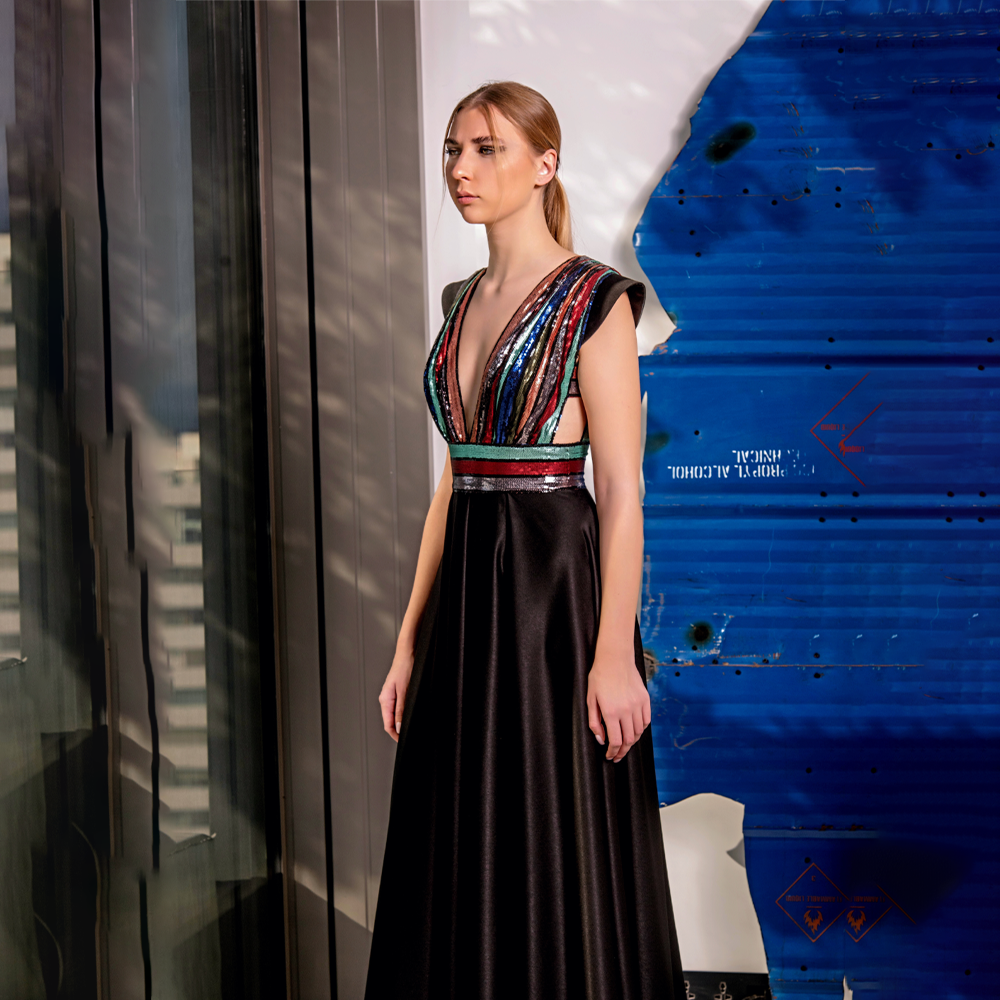 Long dress in black crepe with draped multi-colored sequins.