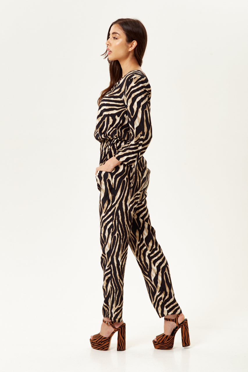 Shop designer dress styles with the bold Women's Zebra Print Jumpsuit for a chic look. Shop Now!