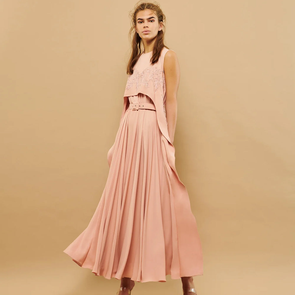 This sleeveless dress boasts a sweetheart cape detail and a belt for a chic, feminine look.