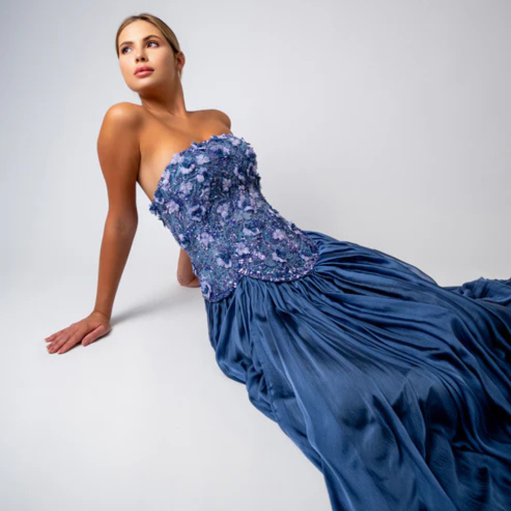Shop online smoky blue gown with sculpted corset, floral embellishments and graceful flowing pleats, perfect for parties and special occasions.