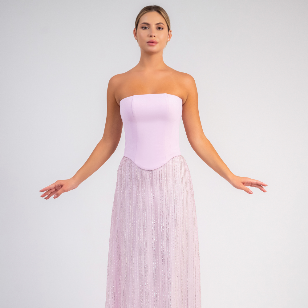 Shop online strapless pastel pink evening gown with structured corset and flowing embellished tulle skirt, perfect for parties and special occasions.