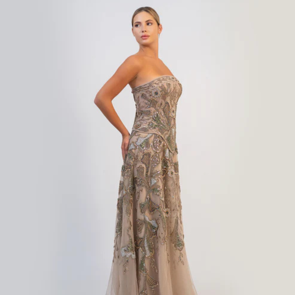 Shop online soft mocha strapless gown with fitted bodice, flowing silhouette and intricate shimmering embellishments, perfect for parties and special occasions.