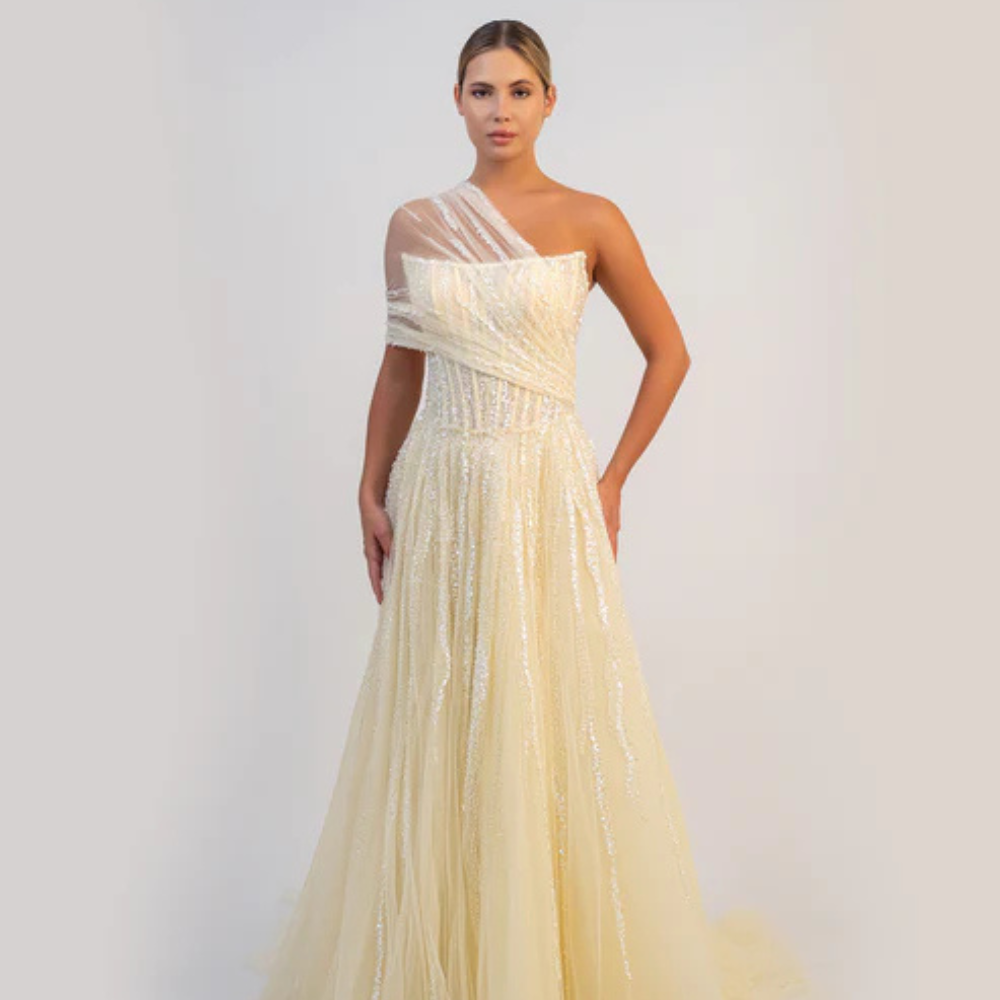 Shop online butter yellow A-line gown with sculpted corset, delicate shimmer and soft draped tulle details, perfect for parties and special occasions.