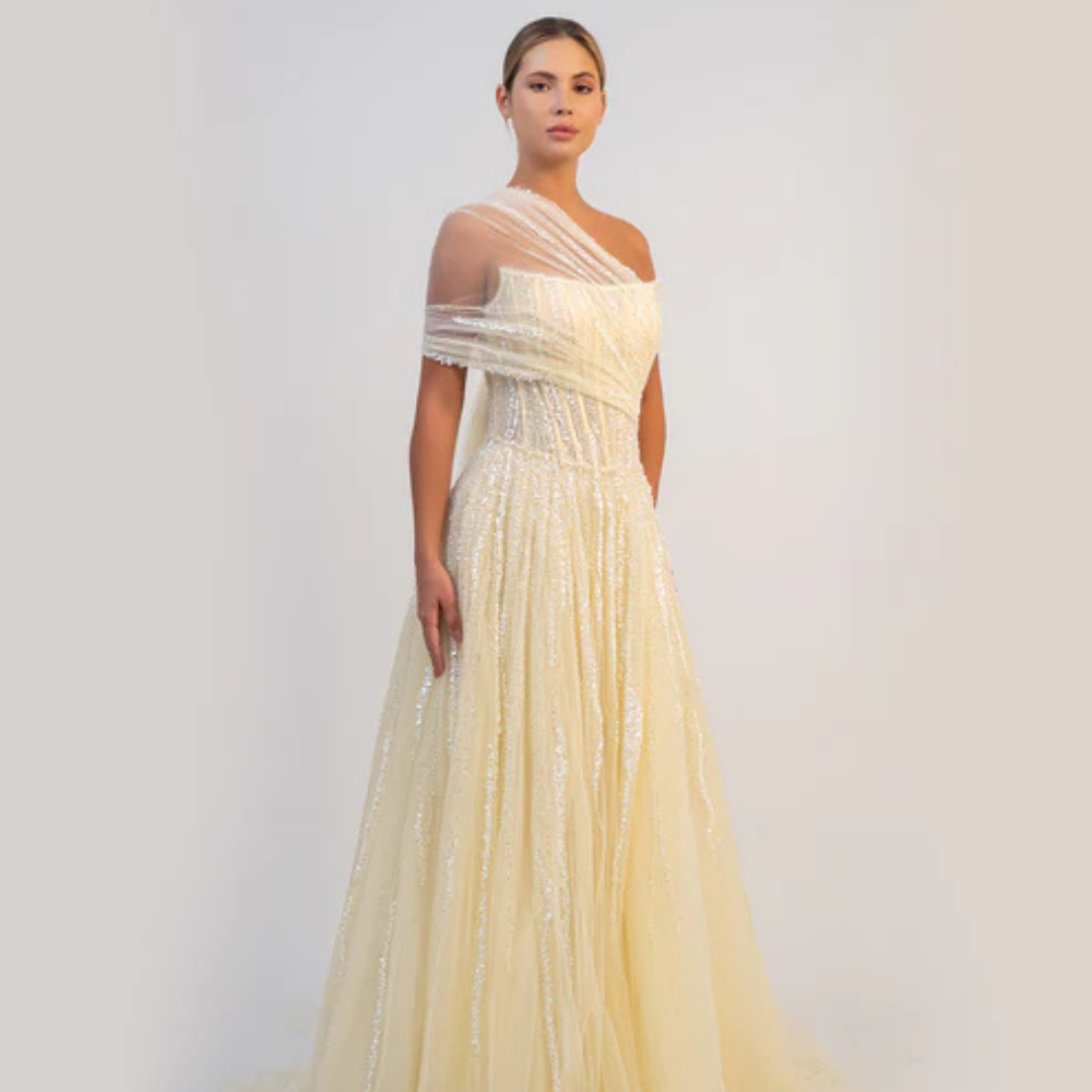 Shop online butter yellow A-line gown with sculpted corset, delicate shimmer and soft draped tulle details, perfect for parties and special occasions.