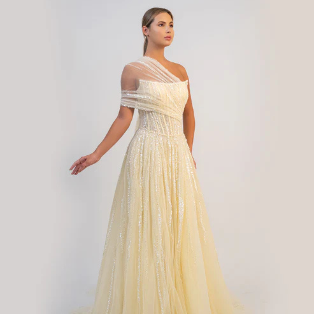 Shop online butter yellow A-line gown with sculpted corset, delicate shimmer and soft draped tulle details, perfect for parties and special occasions.