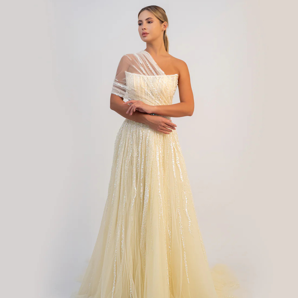 Shop online butter yellow A-line gown with sculpted corset, delicate shimmer and soft draped tulle details, perfect for parties and special occasions.