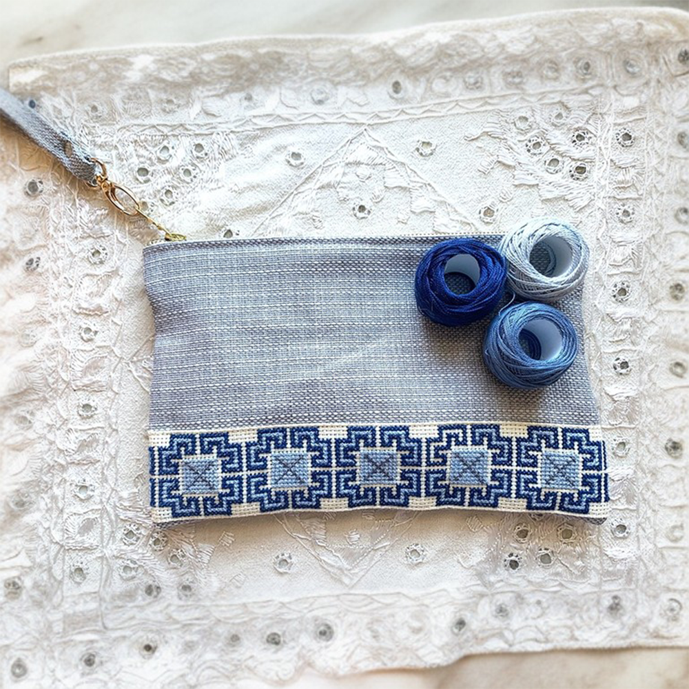 The Accessories Box features a your choice of Tatreez Headband, Key Fob, Scrunchie, and Tatreez Pouch in Blue.