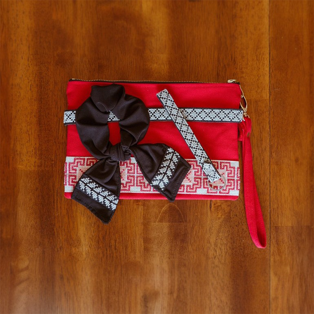 The Accessories Box features your choice of Tatreez Headband, Key Fob, Scrunchie, and Tatreez Pouch in Red.