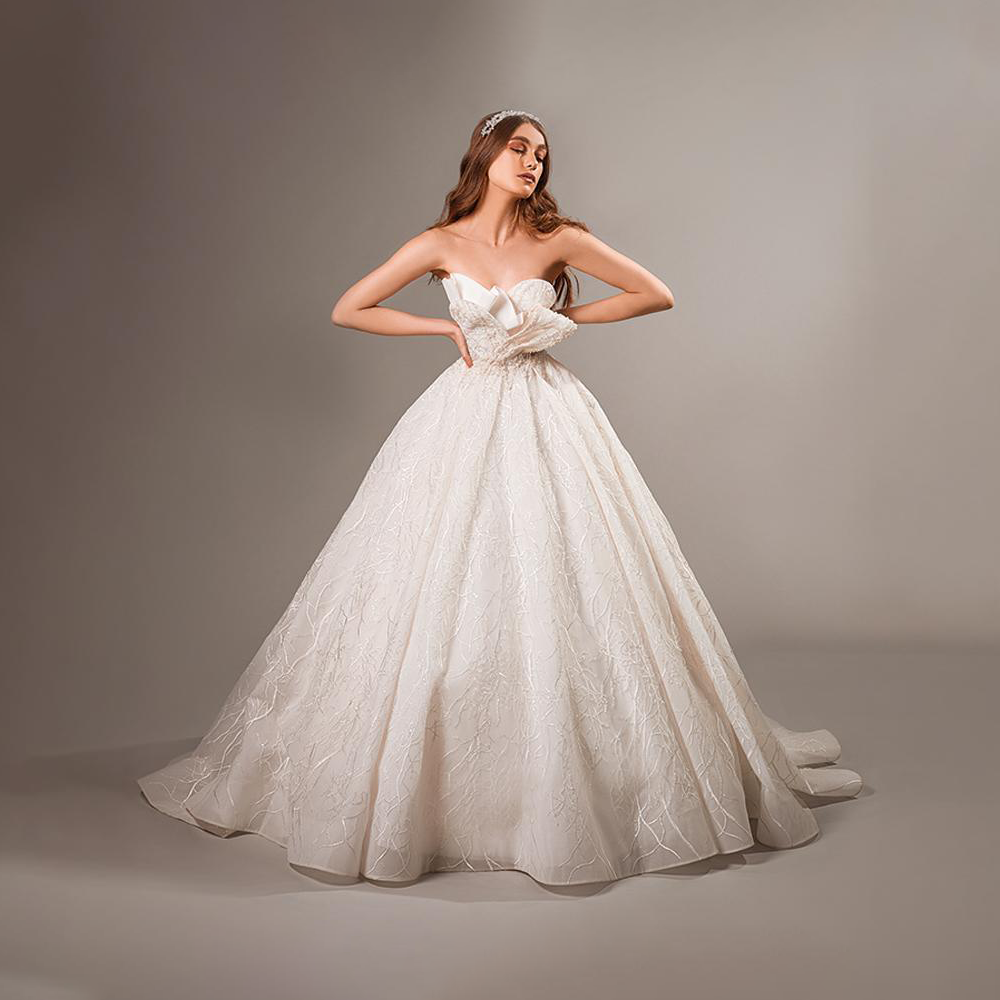 Fancy flared gown with off shoulder look. Soft creations embellished with floral motives and sinuous natural lines