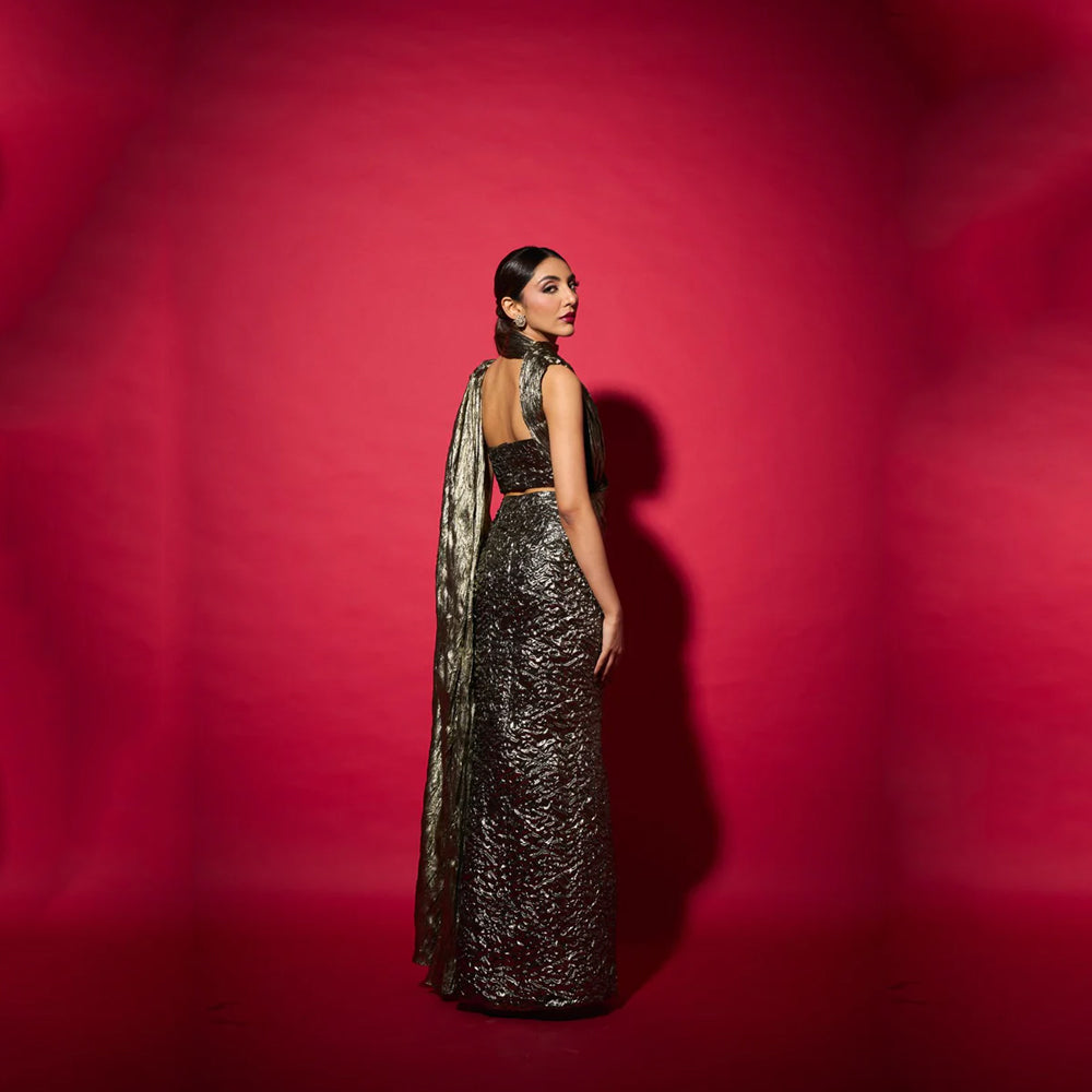 Fusion saree gown with draped neckline and bustier skirt, perfect for events. Shop online from our curated edit of premium fashion.