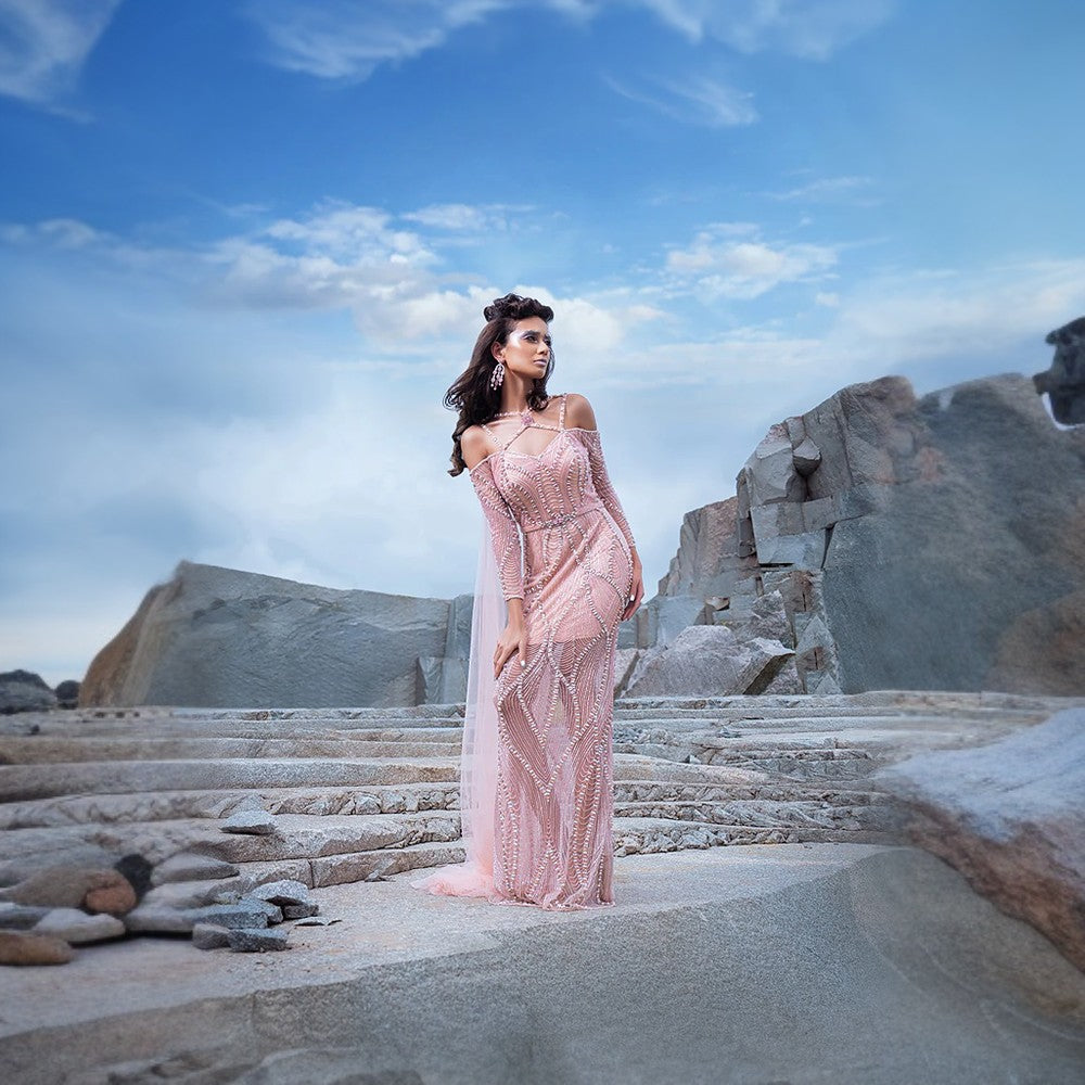 Array of light channeled through undulating geometrical setting of crystals and beads in mermaid silhouette.