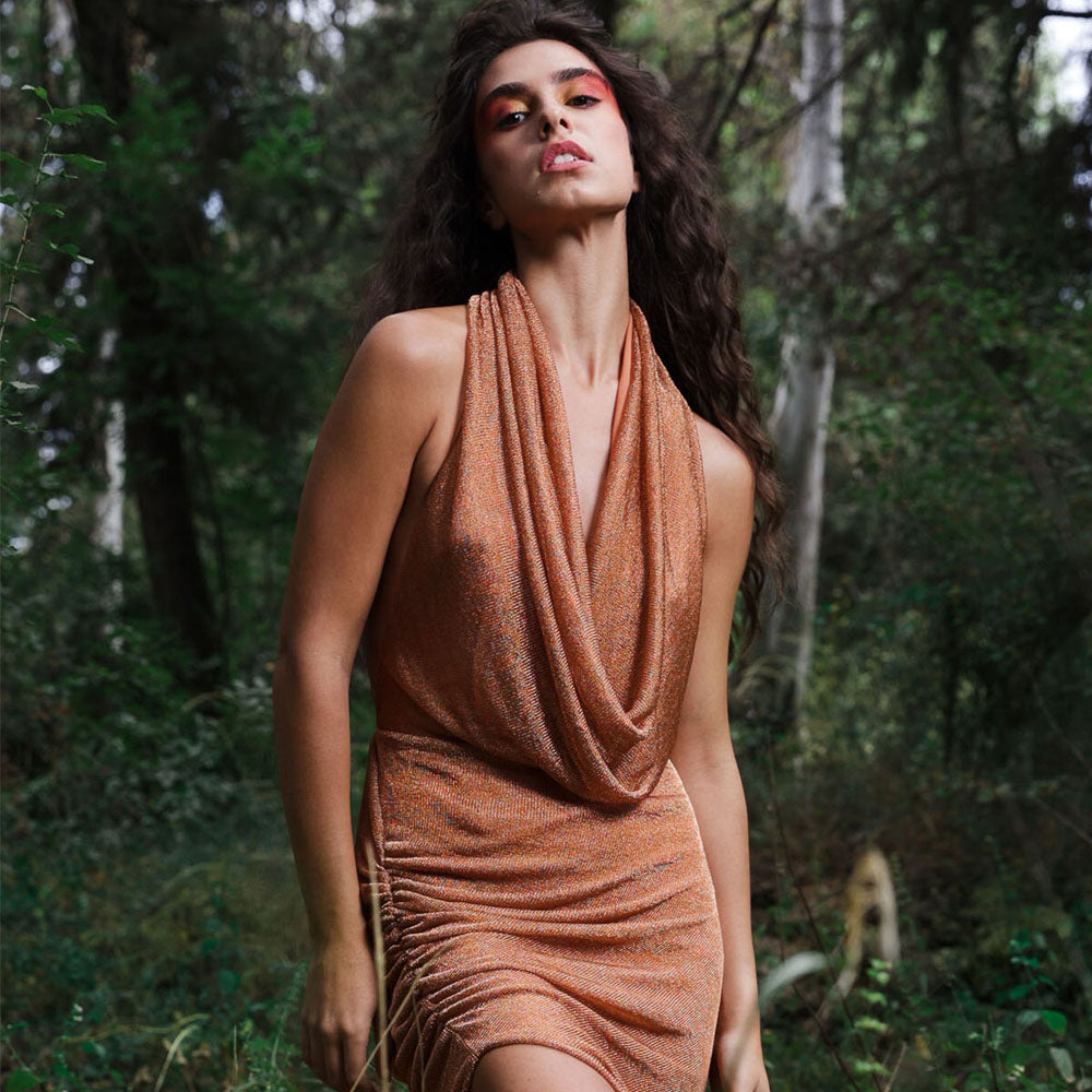 Backless, draped cowl neck dress with side gatherings in shimmer amber color mesh.