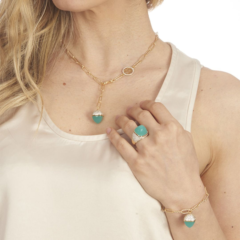 Elegant yellow gold plated bracelet with an amazonite-colored pyramid crystal pendant and sparkling cubic zirconia diamond-cut links. Shop premium jewelry online.