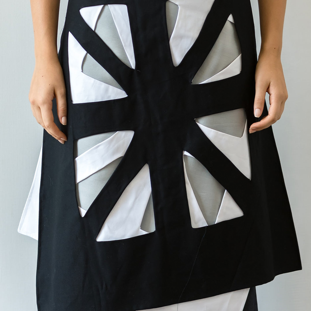 Hand crafted apron skirt inspired by the arabic art 'rub-el-hizb' represented as two overlapping square.