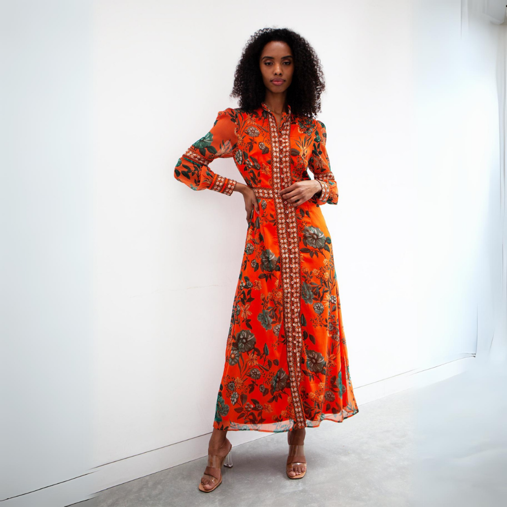 A stunning contrasting print maxi dress with placement print on the cuffs and central button details running down