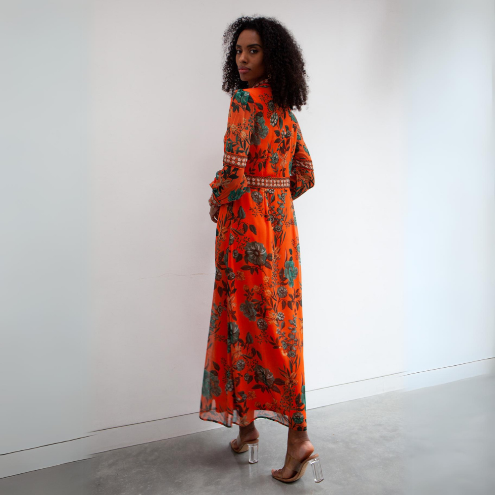 A stunning contrasting print maxi dress with placement print on the cuffs and central button details running down