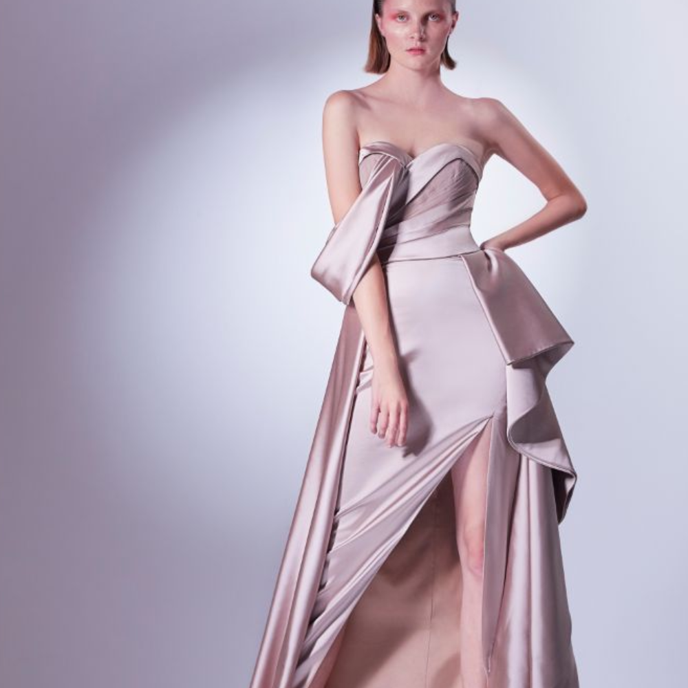Asymmetric off the shoulder dress, designed in nude earthly colors. The bust is a marriage of satin and pleated tulle.