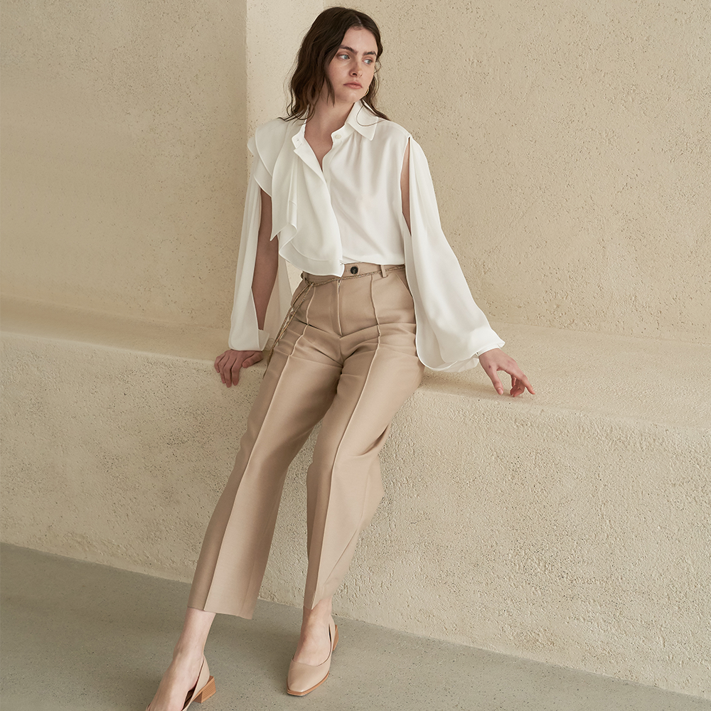 Elevate your style with this asymmetric slit sleeve blouse. Shop Now!