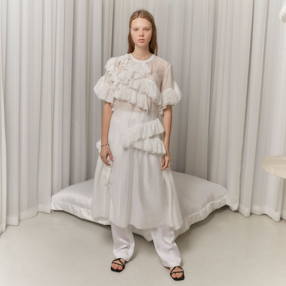 Raw-edged, Round neckline One side handkerchief-hem with patch pocket Adjustable tie belt at waist Relaxed silhouette.