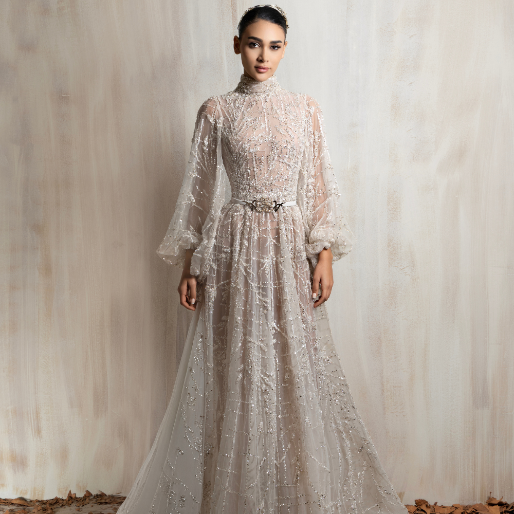 Off-white high-neck beaded gown with sheer long sleeves, offering timeless elegance and sophistication. Shop now at our exclusive clothing website.