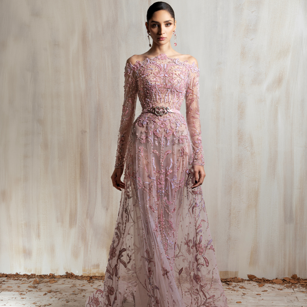 Blush pink embroidered tulle gown with sheer sleeves and a fitted silhouette, designed for timeless elegance. Shop now at our exclusive clothing website.