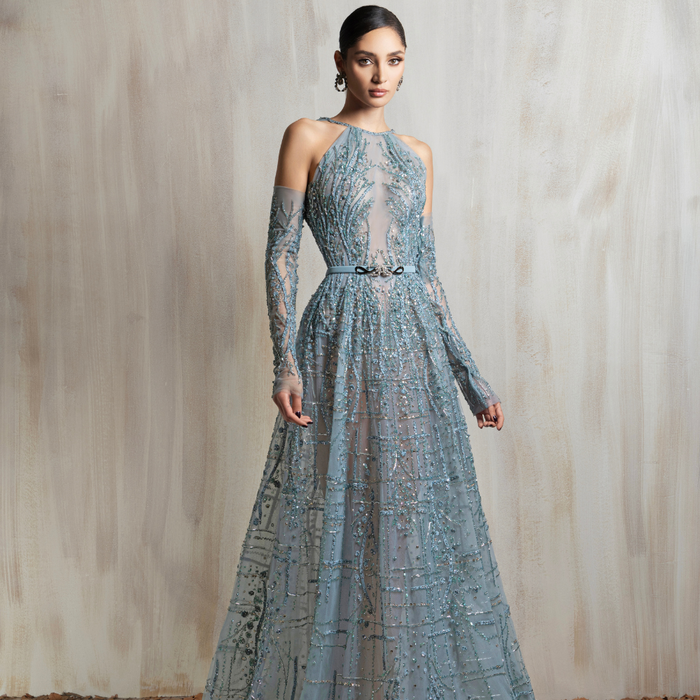 High-neck sheer aqua gown with beaded embroidery, fitted sleeves, and a flared A-line skirt. Shop now at our exclusive clothing website.