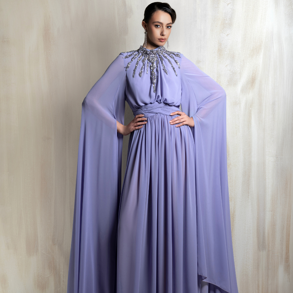 Lavender cape gown with a radiant crystal neckline, crafted for elegant evening occasions. Shop now at our exclusive clothing website.