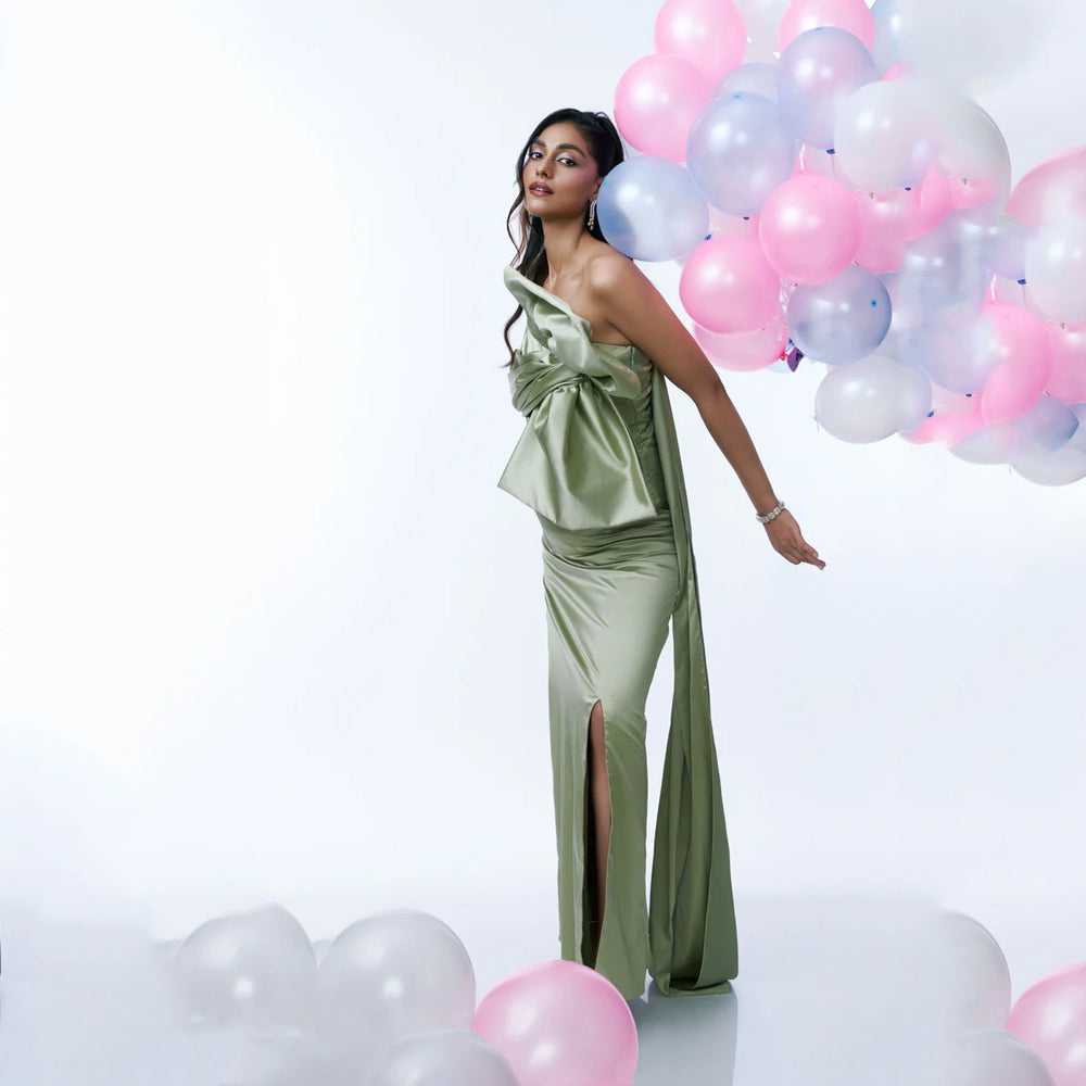 Green satin maternity dress with ruched bust, bow and slit, perfect for events. Shop online from our curated edit of premium fashion.