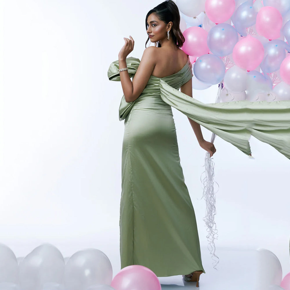Green satin maternity dress with ruched bust, bow and slit, perfect for events. Shop online from our curated edit of premium fashion.