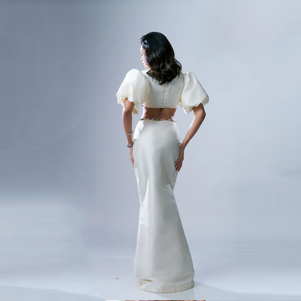 White maxi dress with puff sleeves and rhinestone waist, perfect for events. Shop online from our exclusive collection of premium styles.