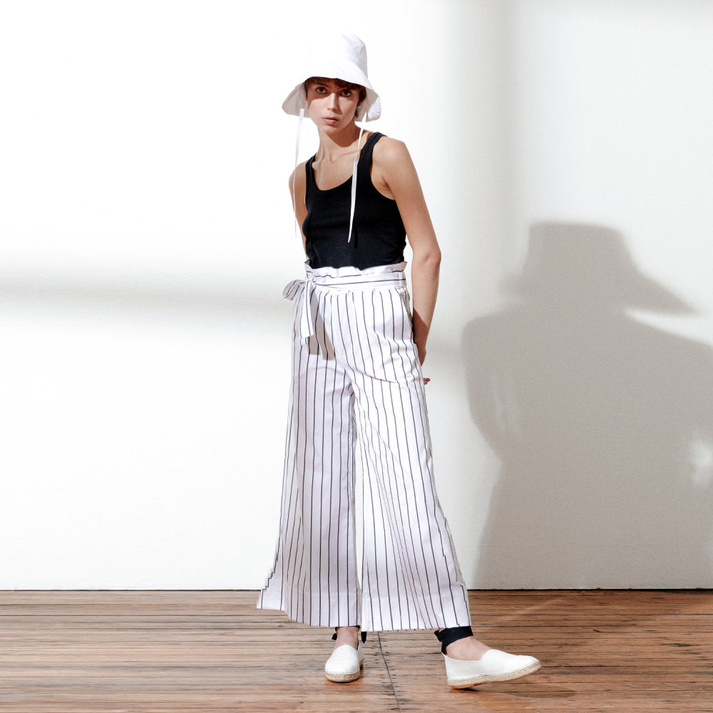 Discover the Aya Trousers at The Luxe Maison, featuring lightweight cotton poplin, a wide-leg ankle-length fit, and a tie belt for effortless holiday styling.