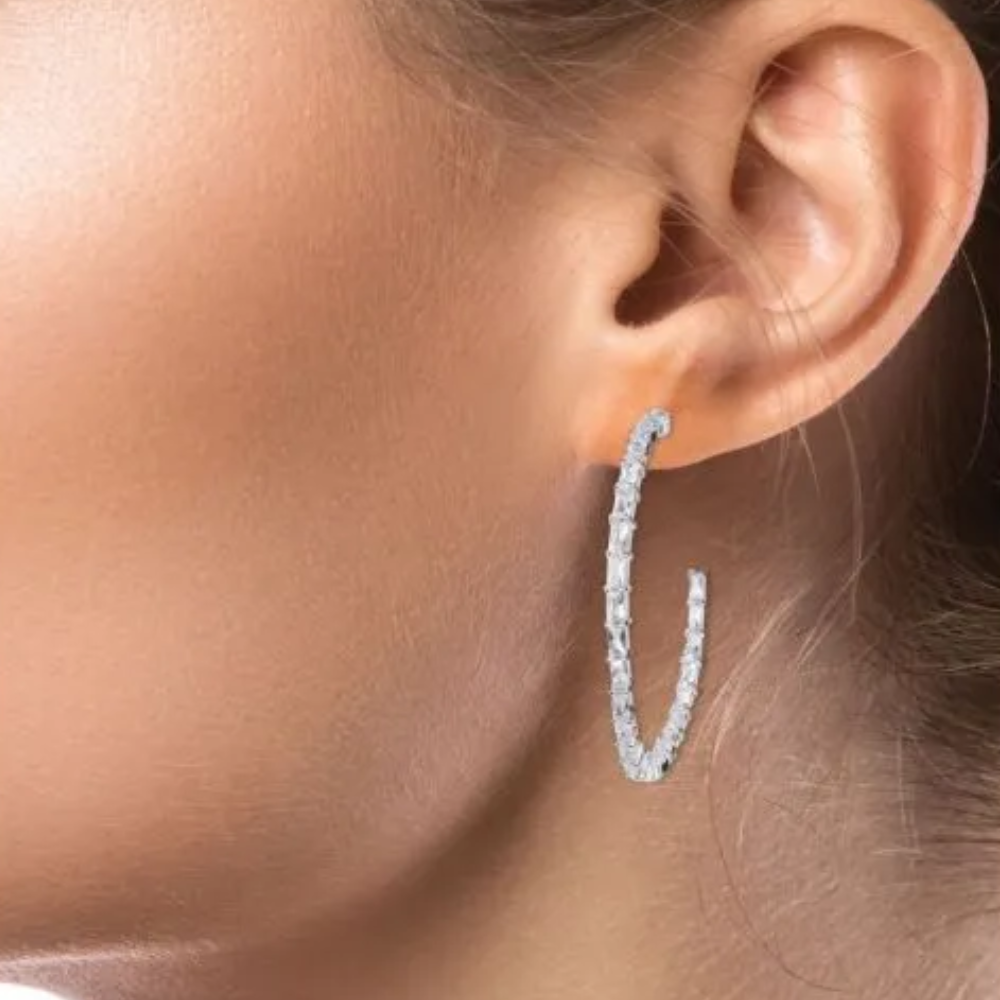12 CTTW baguette cubic zirconia inside-out hoop earrings. Post ear set in rhodium-plated brass.