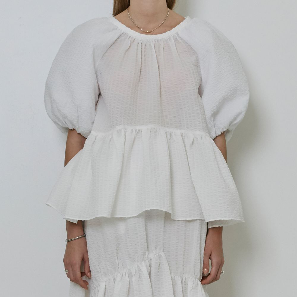 Raw-edged, Round neckline One side handkerchief-hem with patch pocket Adjustable tie belt at waist Relaxed silhouette.