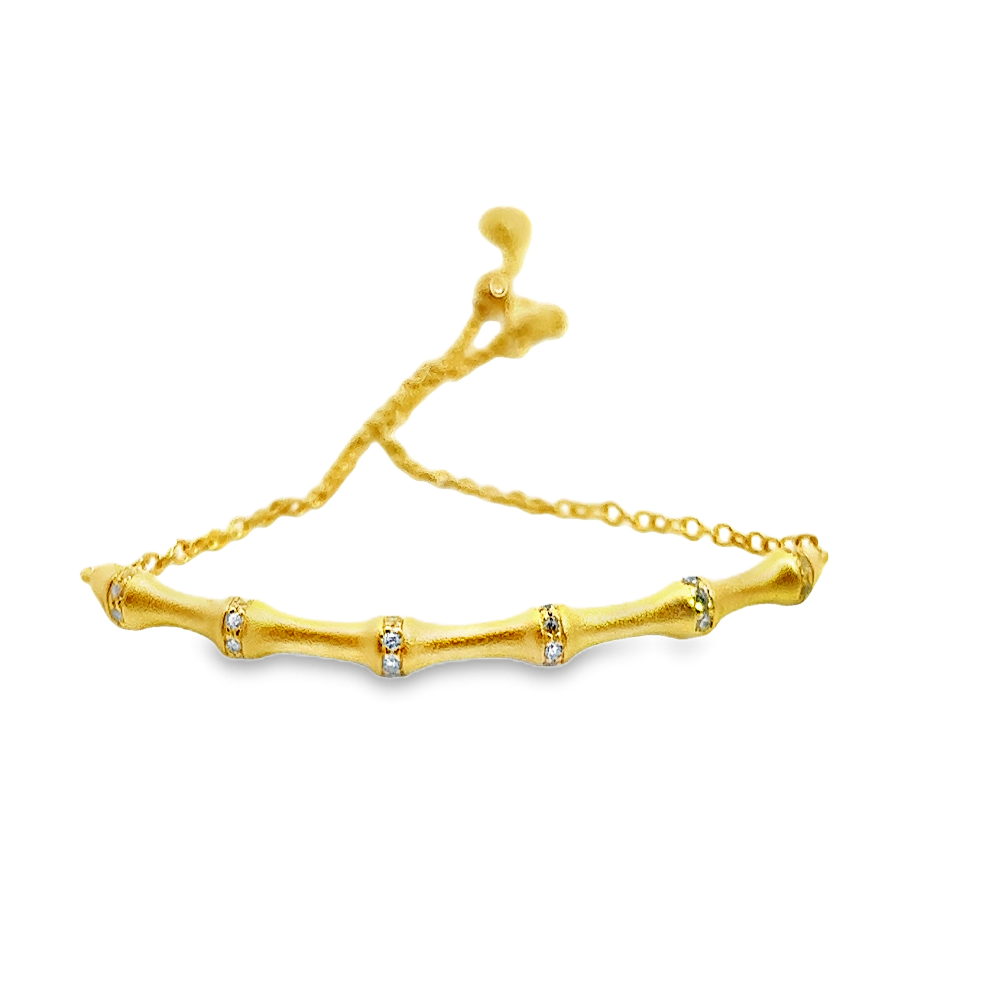 Sterling silver 18k gold-dipped bamboo bracelet with cubic zirconia accents for a sleek contemporary style. Shop premium jewelry online.