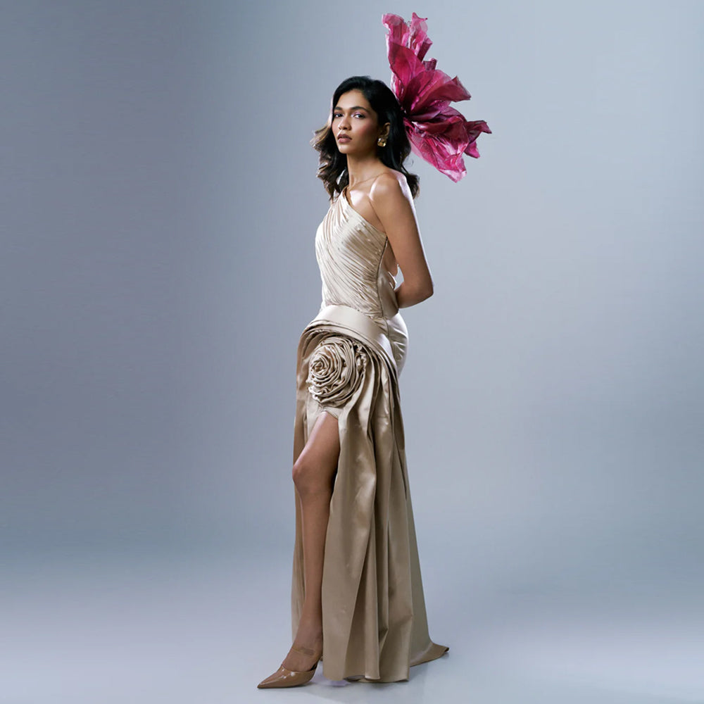 Soft gold satin one shoulder gown with pleats and slit, perfect for weddings. Shop online from our exclusive collection of premium styles.