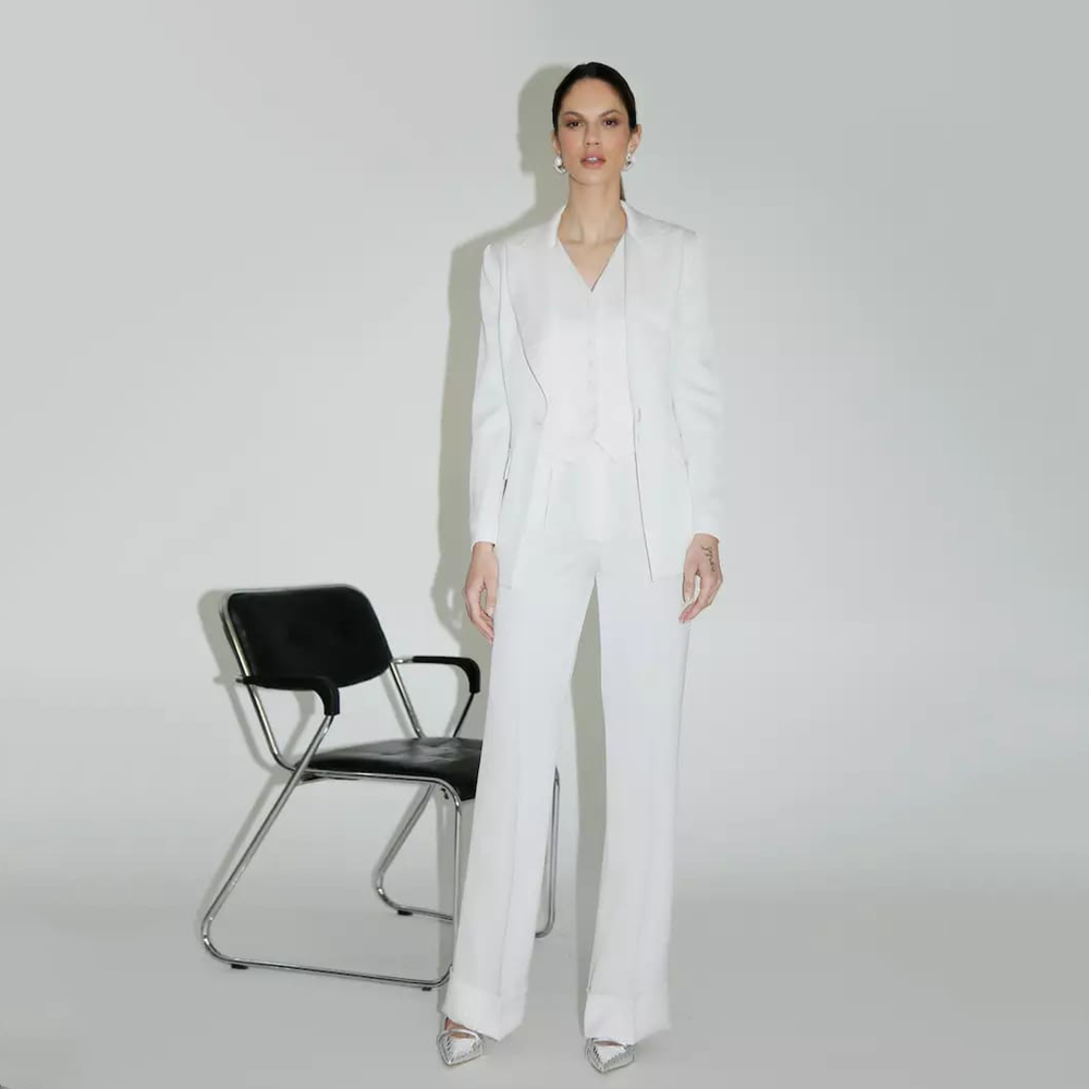This Bianca Blazer in white features side pockets and is made with acetate, silk, viscose, and spandex. 