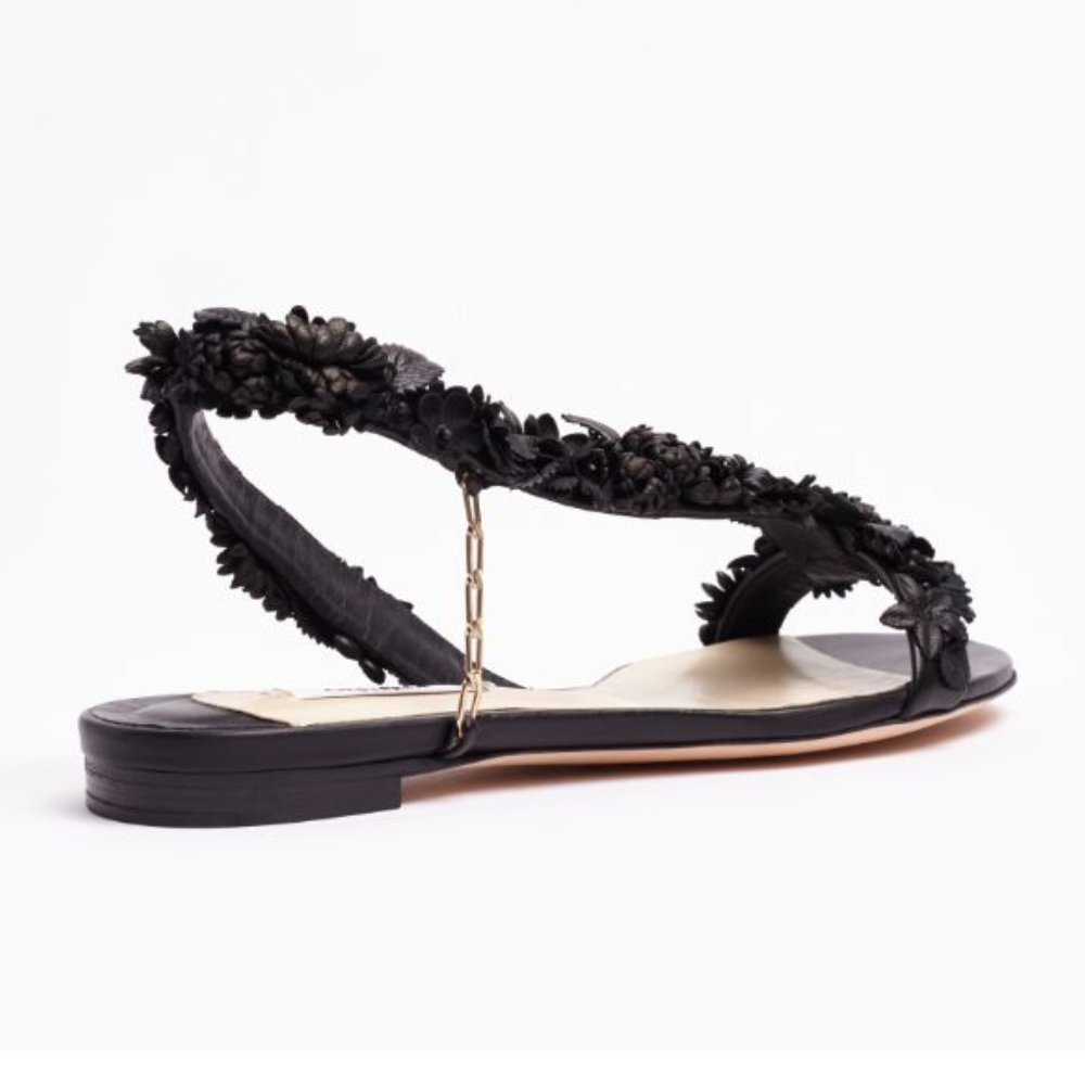 The L’Amazone Mon Bijoux flat sandal is designed in rich black double satin adorned with embellishments at its toe band. 