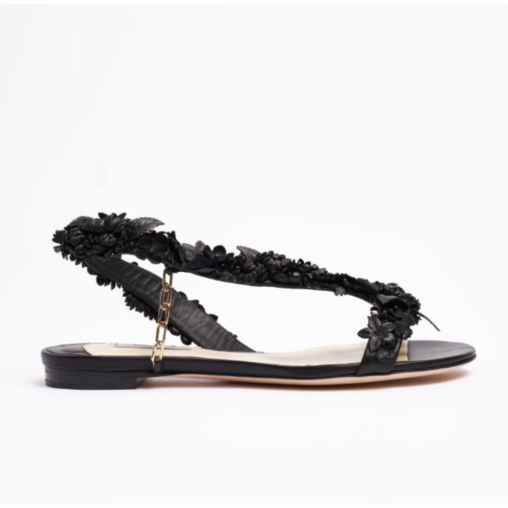 The L’Amazone Mon Bijoux flat sandal is designed in rich black double satin adorned with embellishments at its toe band. 