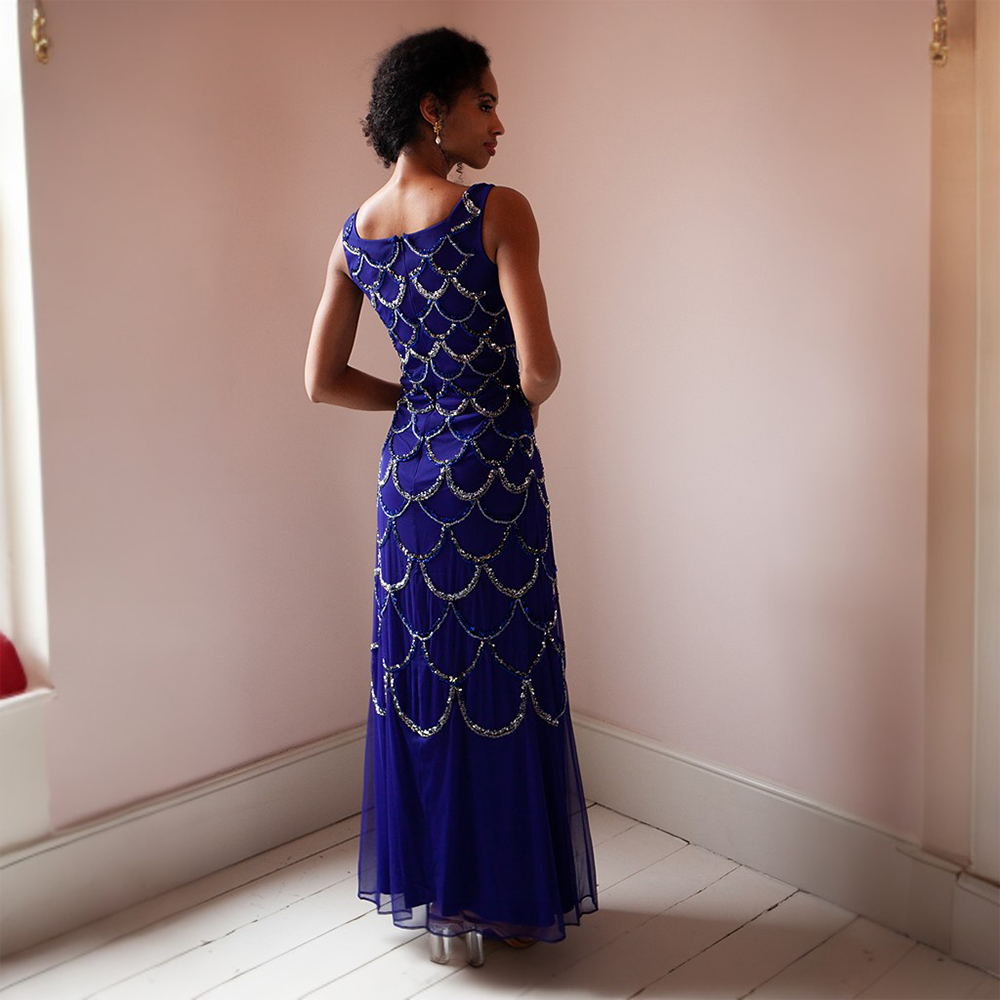 This glamorous blue floor-length gown features gold and silver sequins as well as a cape that can be taken on or off