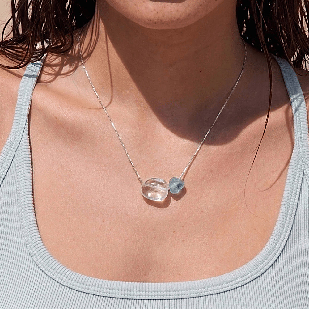 Discover the Blue Hour Aquamarine & Clear Quartz Silver Necklace at The Luxe Maison, featuring a luminous clear quartz crystal, a delicate aquamarine bead, and an S925 sterling silver chain for an elegant, ocean-inspired look.