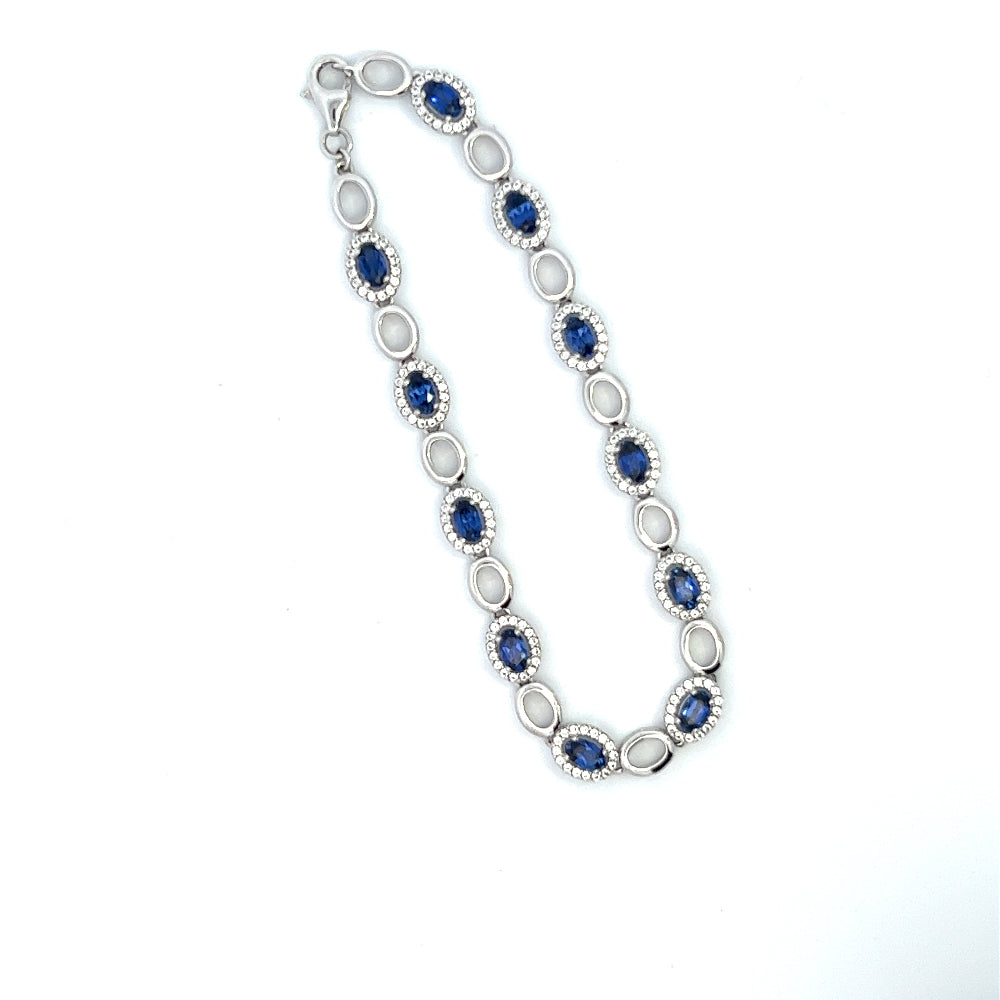 Sterling silver rhodium plated bracelet with lab-created blue sapphires and sparkling cubic zirconia for a sleek timeless statement. Shop premium jewelry online.