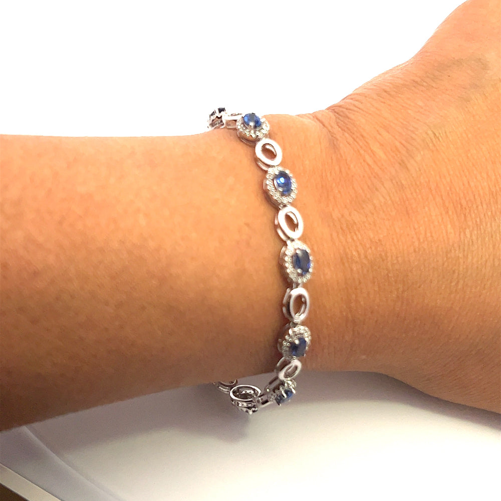 Sterling silver rhodium plated bracelet with lab-created blue sapphires and sparkling cubic zirconia for a sleek timeless statement. Shop premium jewelry online.