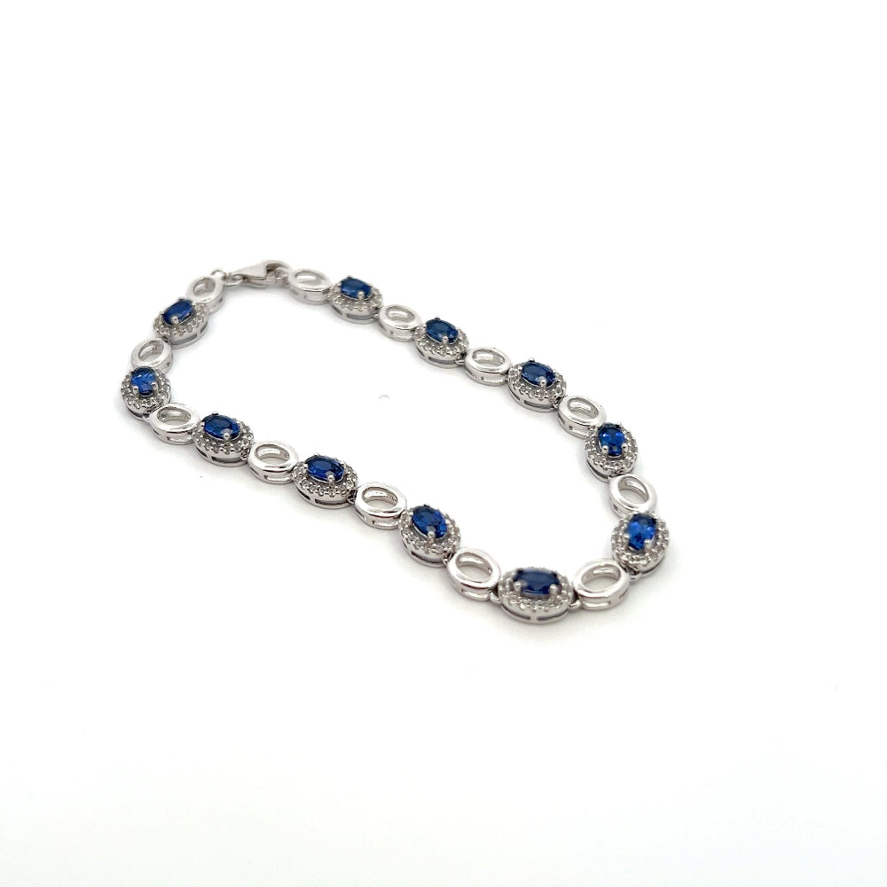 Sterling silver rhodium plated bracelet with lab-created blue sapphires and sparkling cubic zirconia for a sleek timeless statement. Shop premium jewelry online.