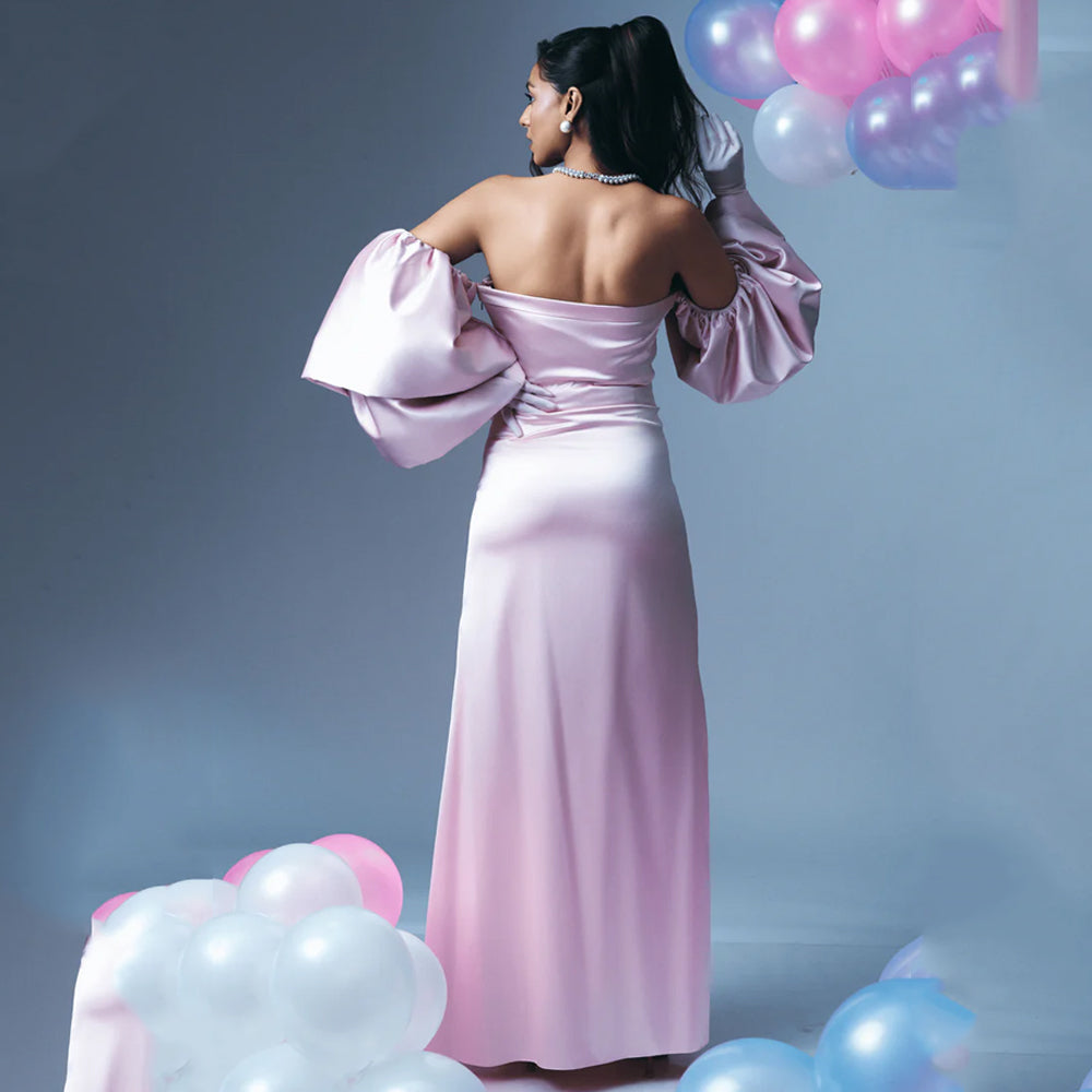 Blush pink satin maternity dress with off shoulder sleeves and A-line fit, perfect for baby showers. Shop online from our curated edit of premium fashion.