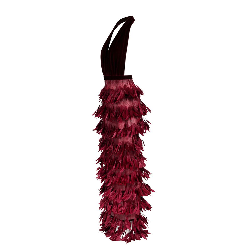 A Burgundy velvet dress with a deep V neckline and a skirt in ruffled feathers