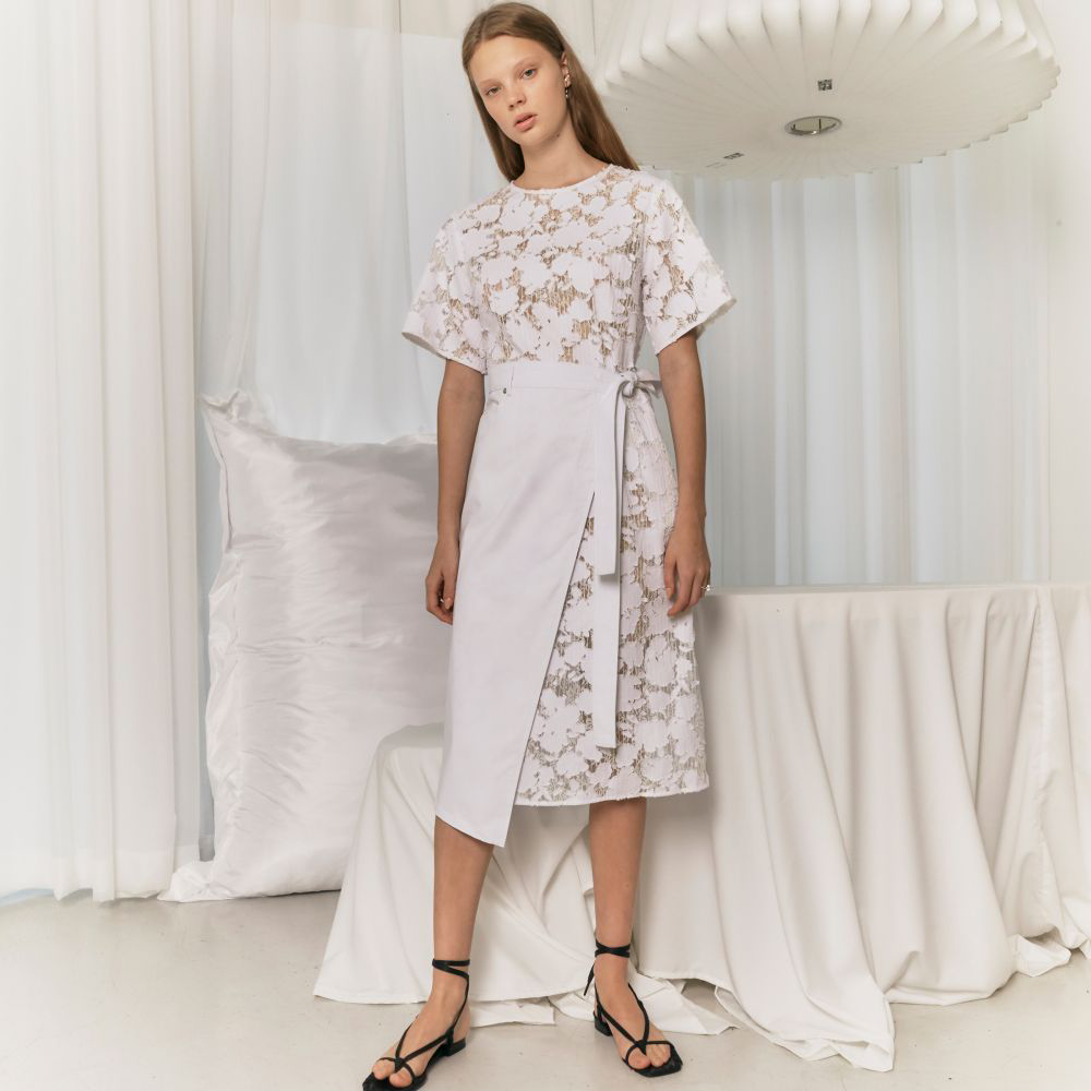 Raw-edged, Round neckline One side handkerchief-hem with patch pocket Adjustable tie belt at waist Relaxed silhouette.